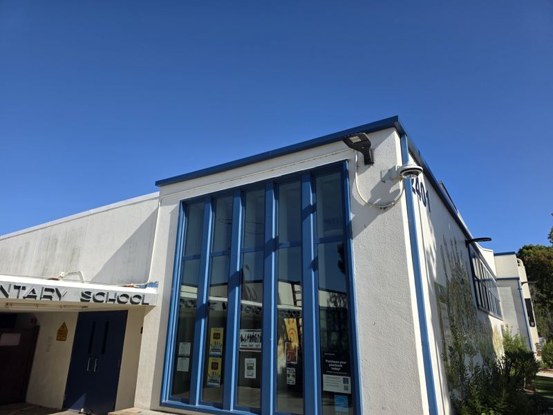 Blue metal edge and downspouts on an elementary school building